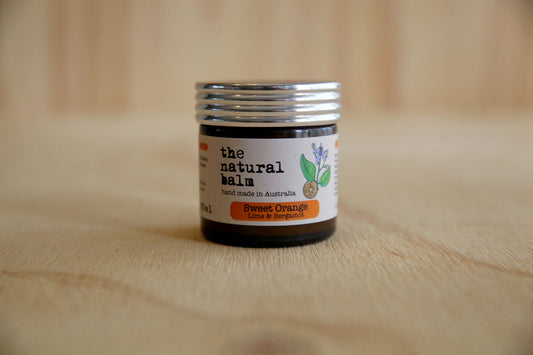 Jar of 'the natural balm' on a wooden surface