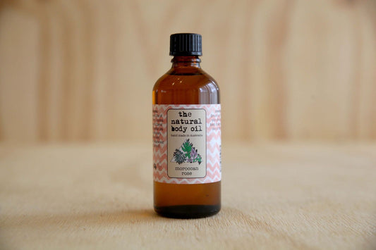 Bottle of 'the natural body oil' on a wooden surface