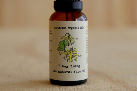 Ylang Ylang natural face oil bottle with label on a wooden surface