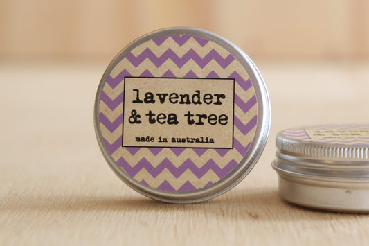 Tin with lavender and tea tree label on a wooden surface