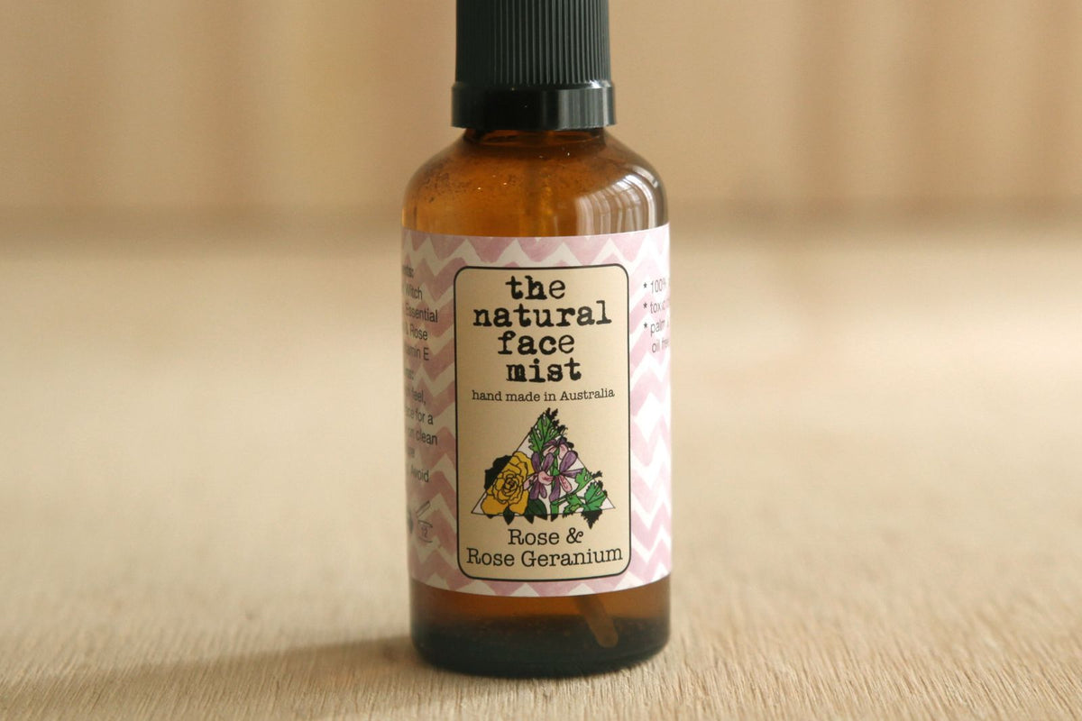 Bottle of 'the natural face mist' with a floral label on a beige background