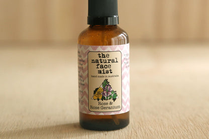 Bottle of 'the natural face mist' with a floral label on a beige background