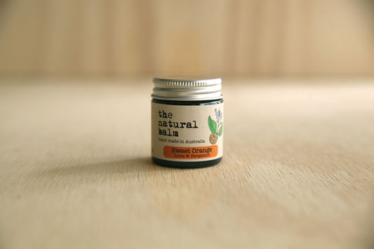 Jar of 'the natural balm' on a wooden surface